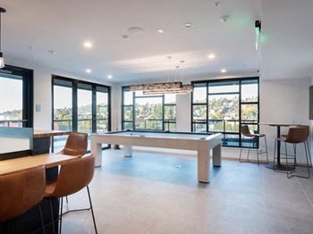 A room with a pool table and chairs.at Axle, Washington, 98119